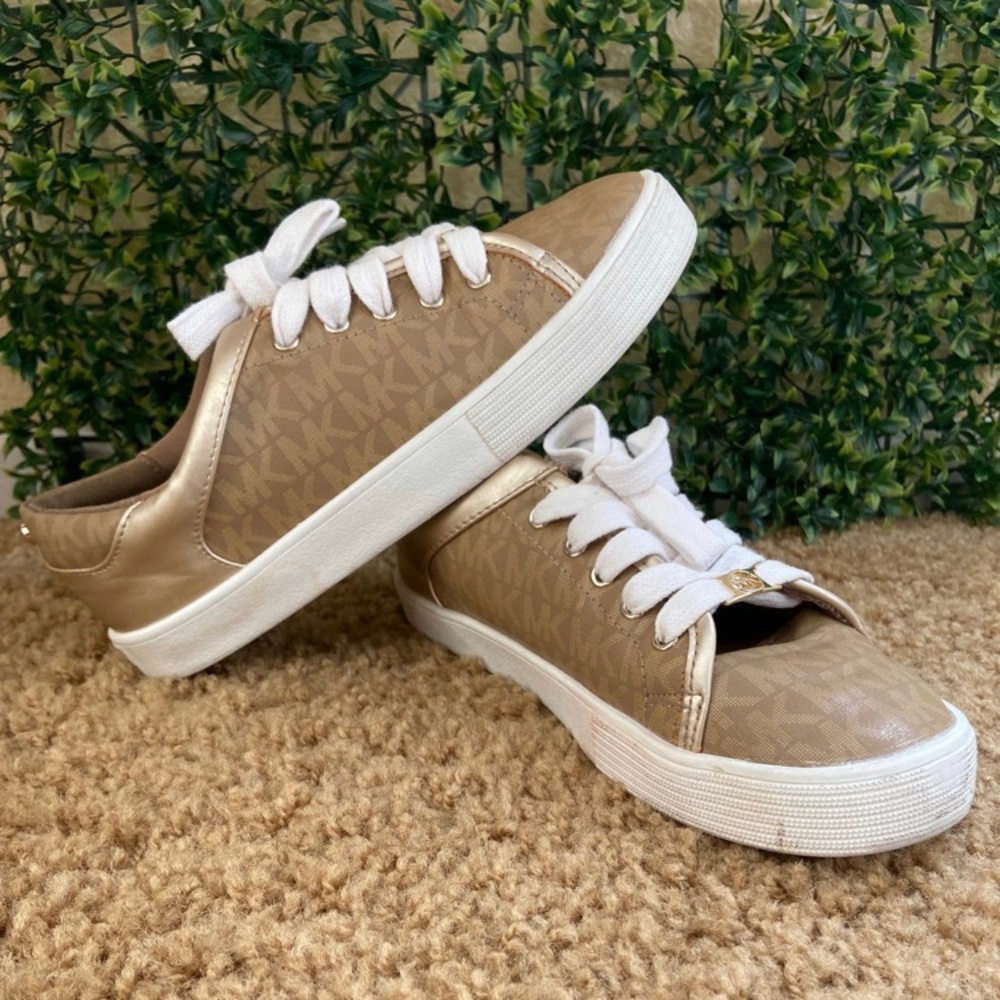 Michael Kors shoes are used, gold color with white they are number 3.